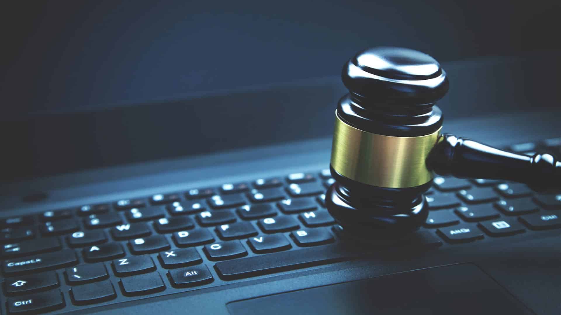law firm website mistakes concept photo of gavel pounding a computer keyboard